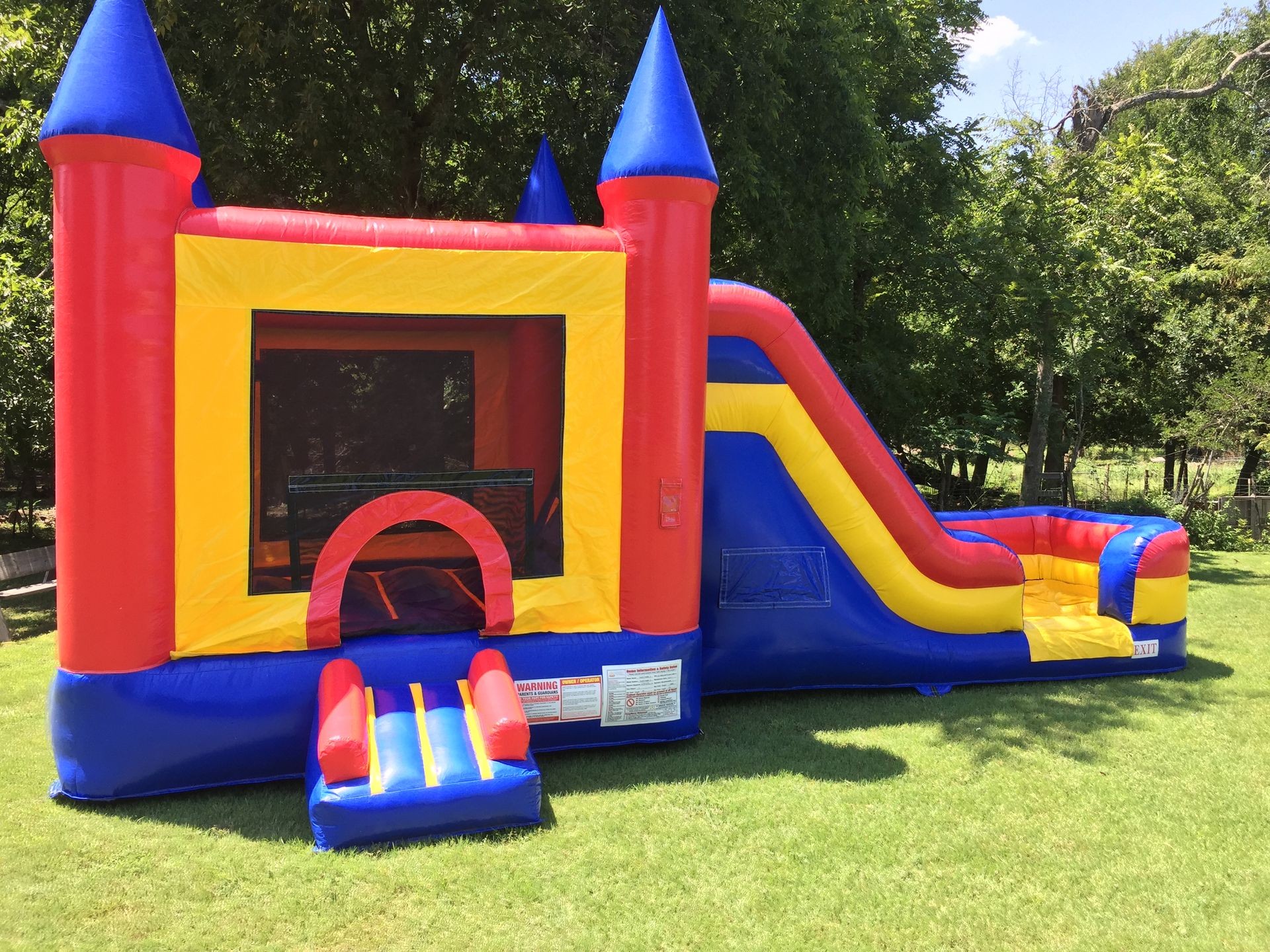 red, blue, yellow bounce house outside